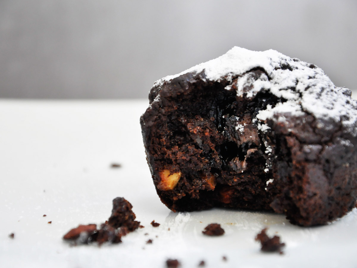 Vegan dark Chocolate Muffins with Carob Powder and Caramelized Walnuts bite