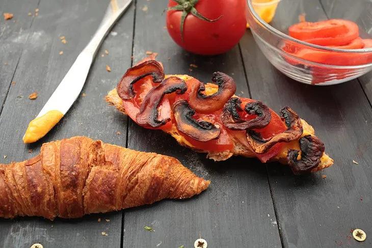 vegan mushroom bacon in croissant sandwich