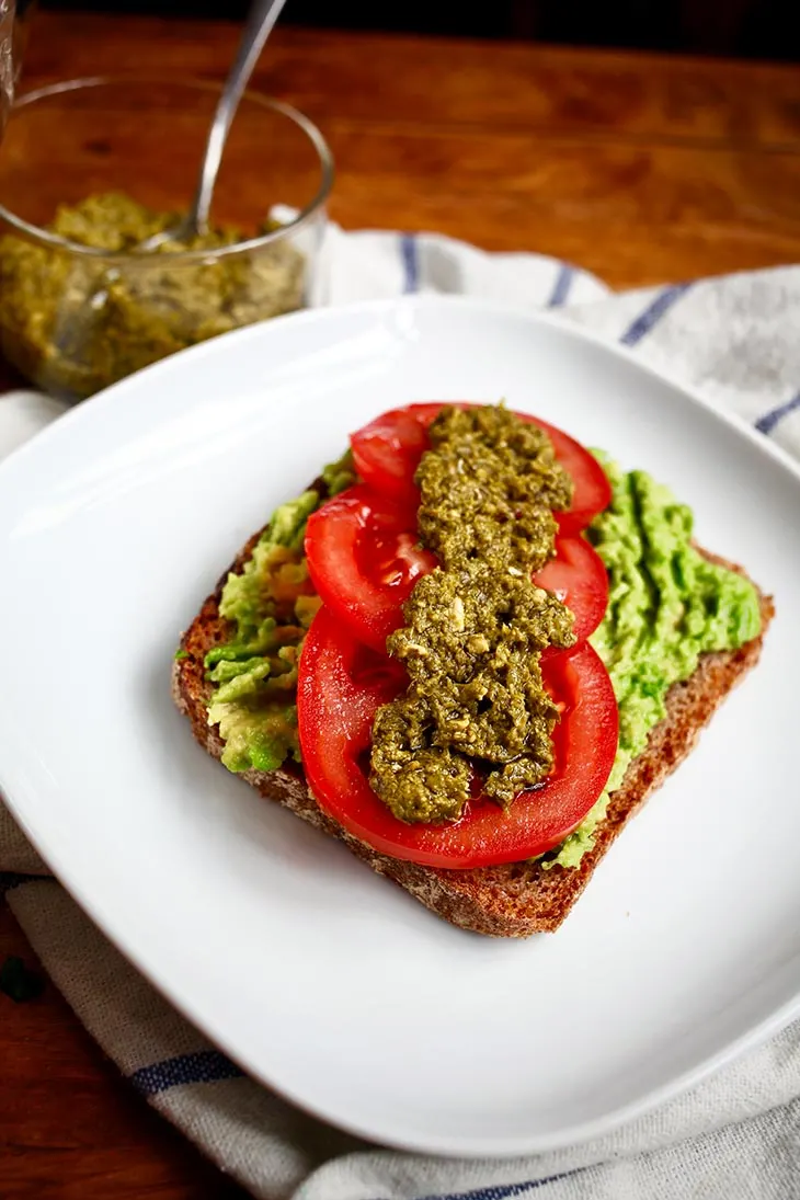 Vegan Smashed Avocado Toast with Basil Pesto and Tomatoes