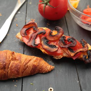 vegan mushroom bacon in croissant sandwich