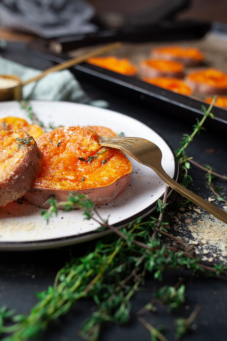 garlicky smashed sweet potatoes on a plate