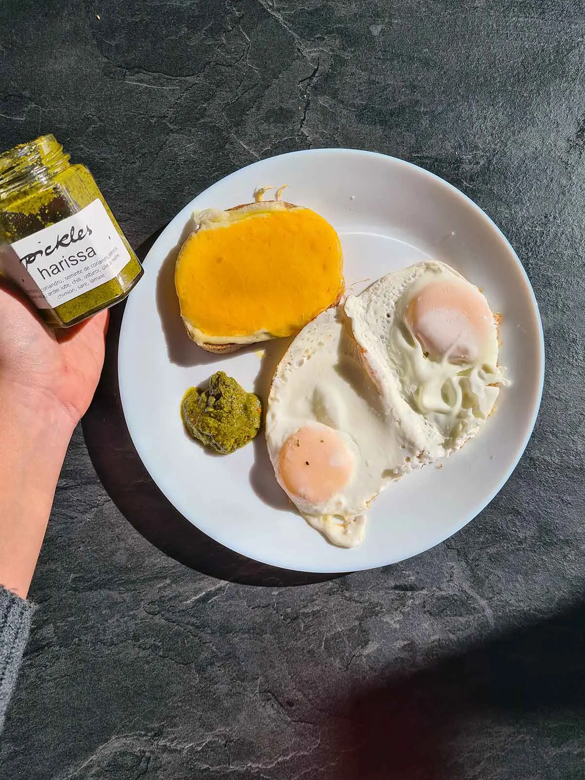 Breakfast with fried eggs, harissa and grilled cheese toast