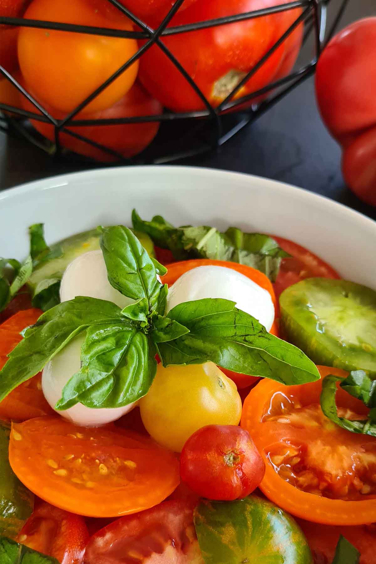 Summer tomato salad with fresh mozzarella and basil pesto