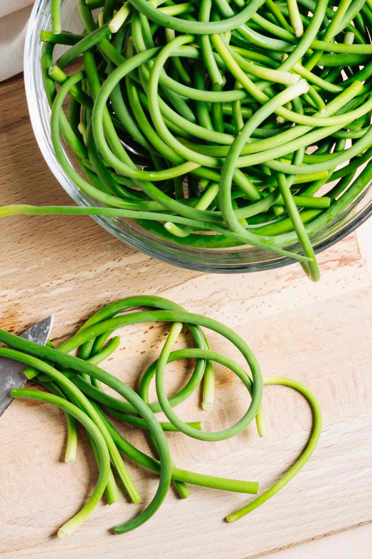 A plate of sautéed garlic scapes ready to serve as a side