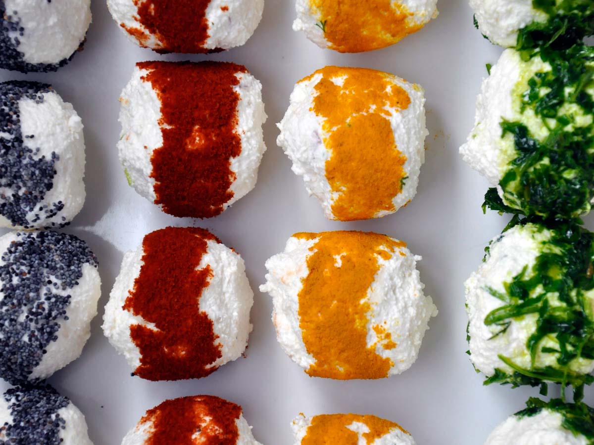 A platter of mini cheese balls rolled in assorted colourful coatings