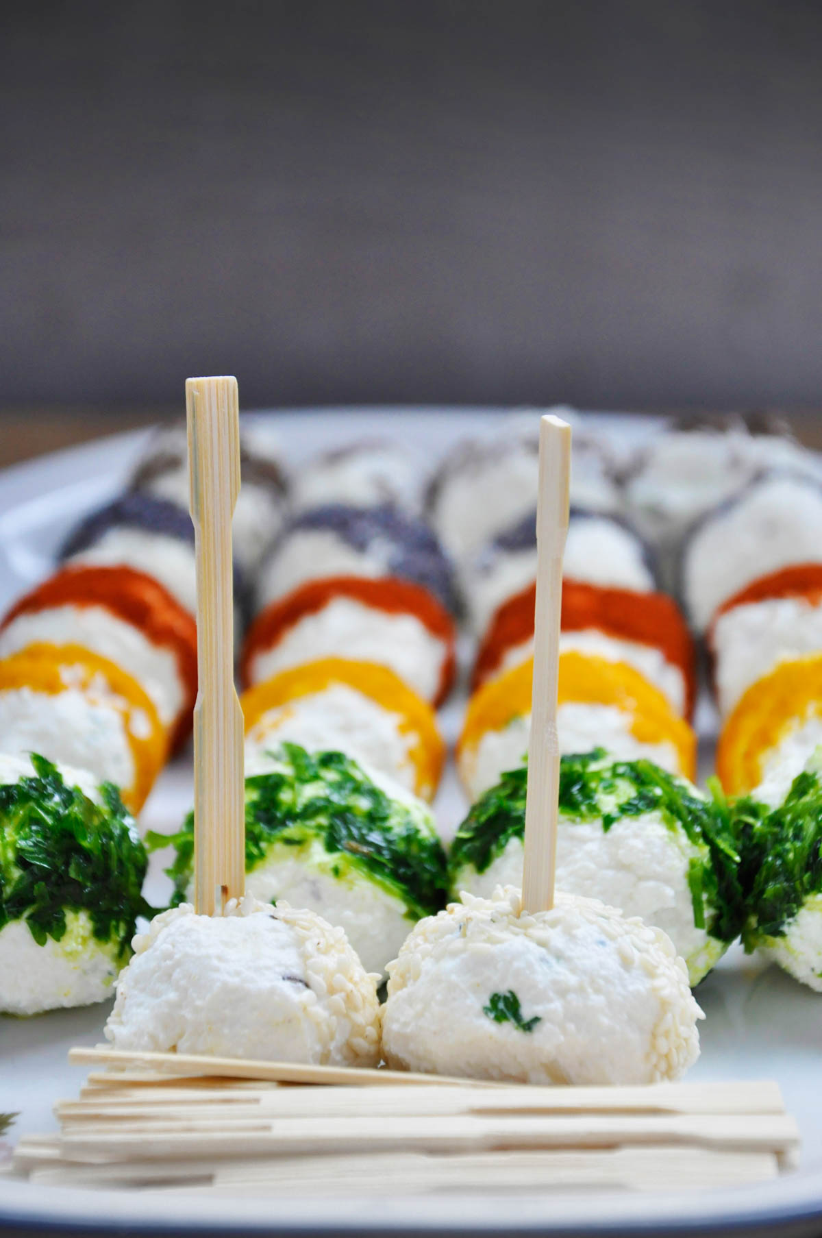 Cheese balls coated in poppy seeds and paprika, four ways