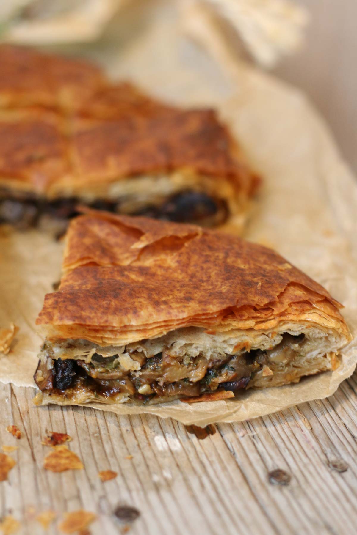 Baked mushroom filo pie on a wooden board