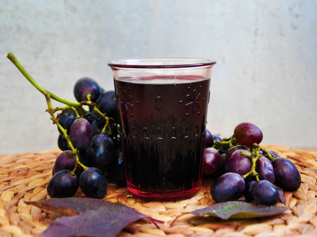 Blackcurrant and grape juice with fresh blackcurrants and grapes