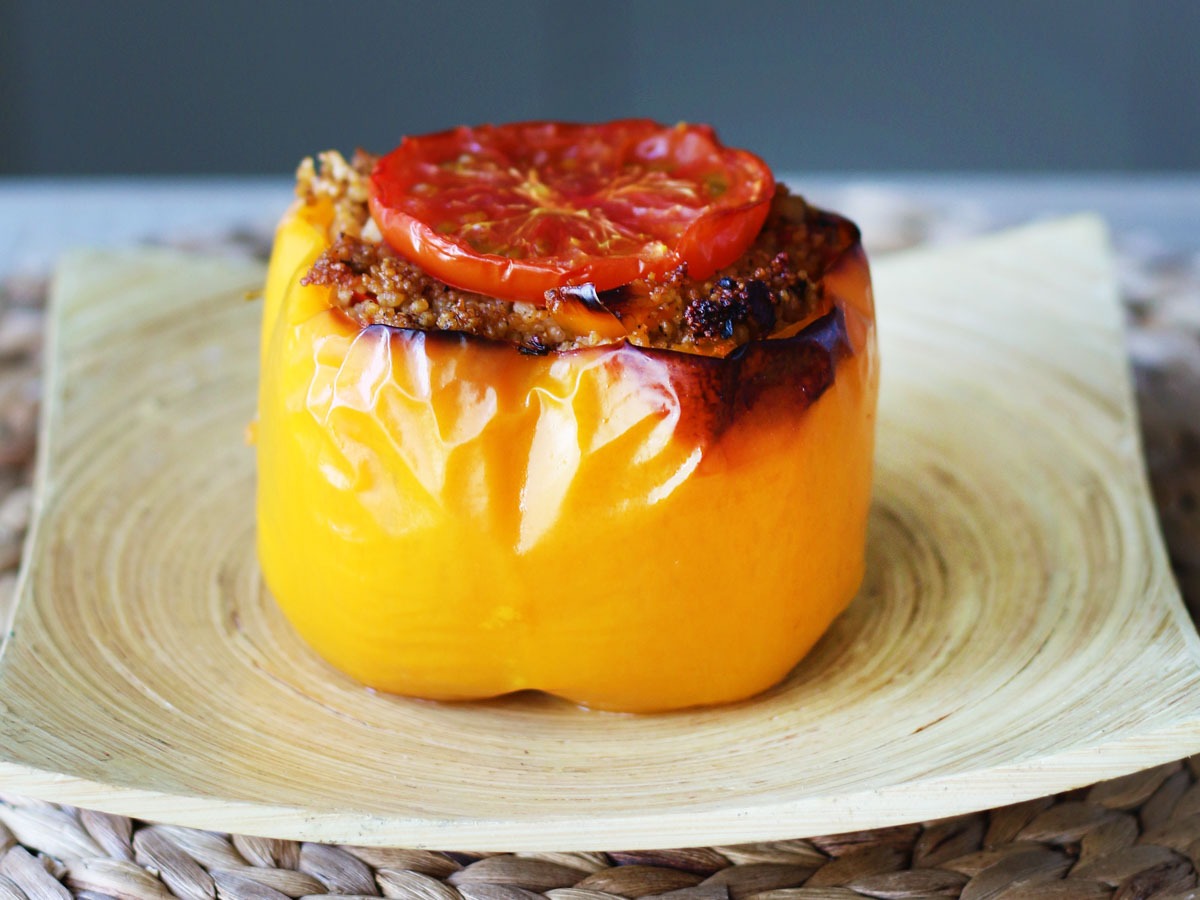 Baked couscous stuffed peppers in a dish