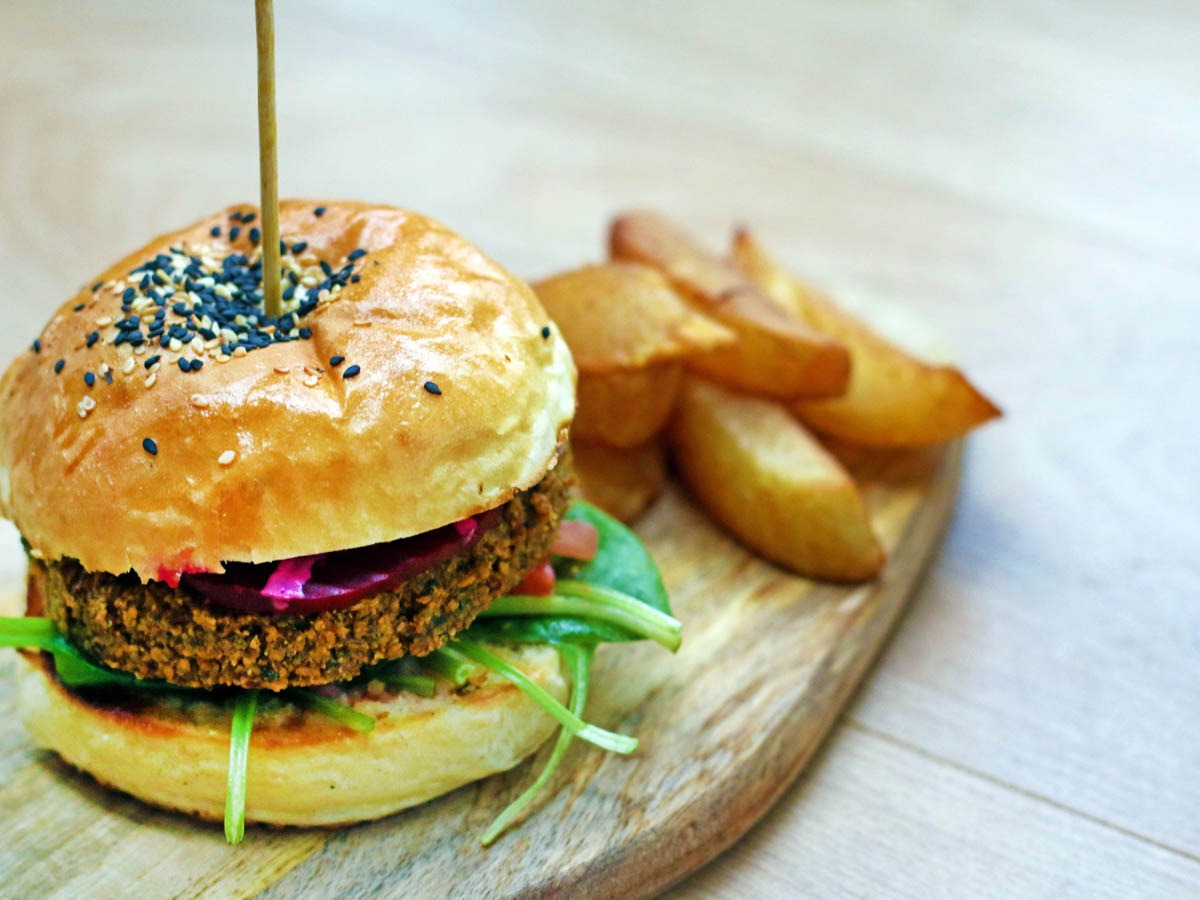 Falafel burger served with potato wedges