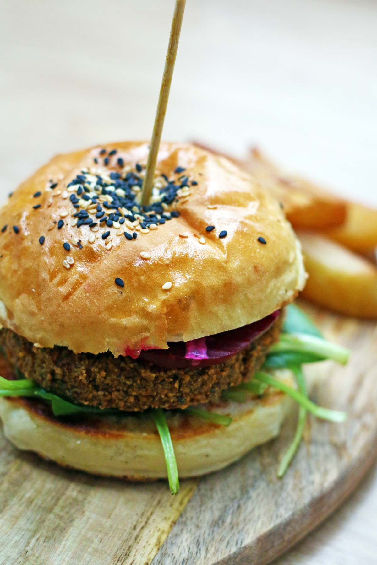 Falafel burger drizzled with creamy tahini sauce