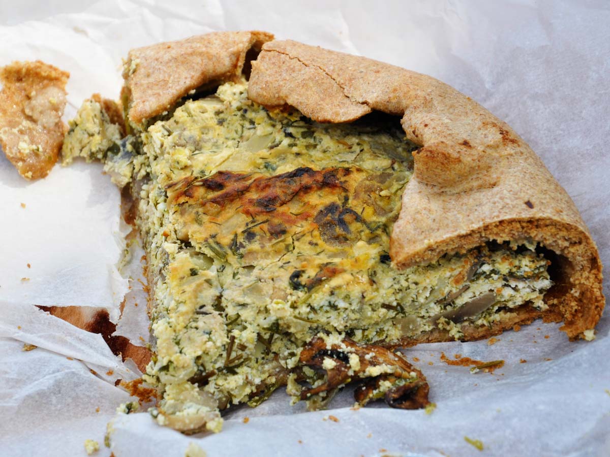 A slice of mushroom and cheese galette with creamy filling