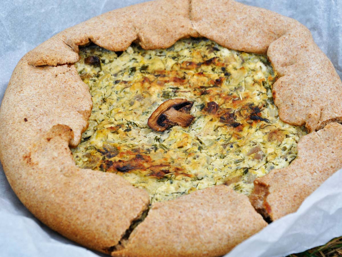 Rustic mushroom and cheese galette on parchment