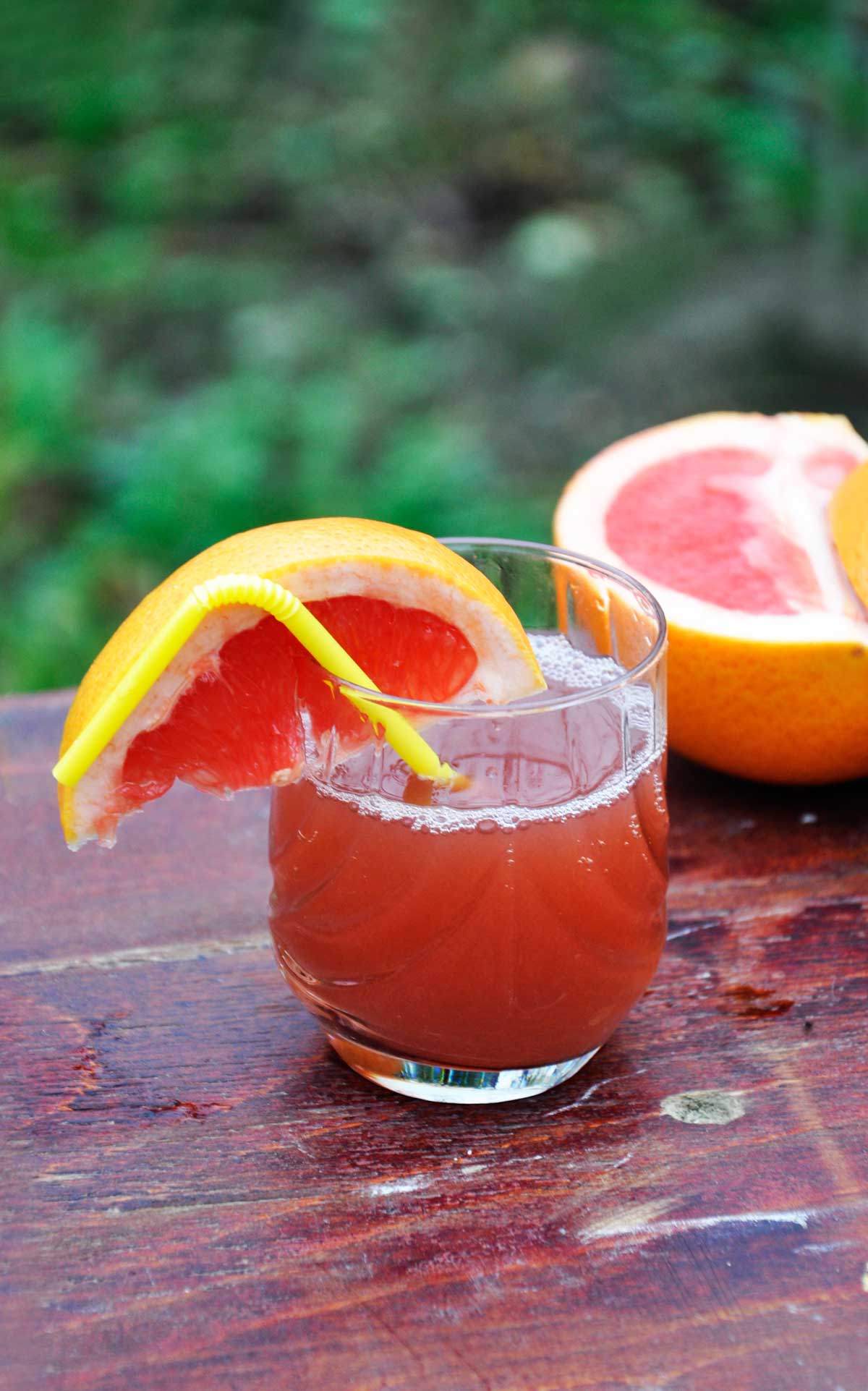 Fresh grapefruit and strawberry juice in a glass with a grapefruit wedge