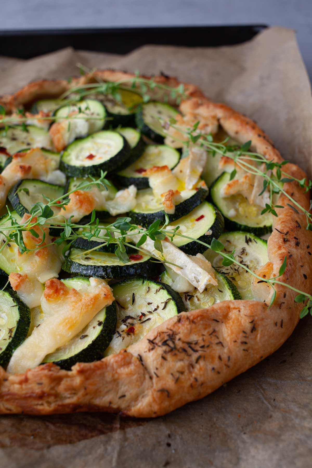 Rustic free-form zucchini galette with folded pastry edges