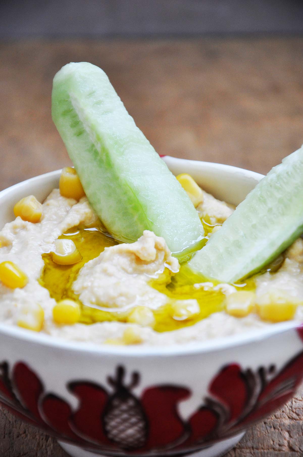 Sweet corn hummus in a bowl drizzled with olive oil