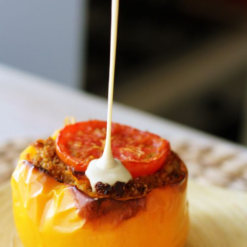 Couscous stuffed peppers topped with herbs