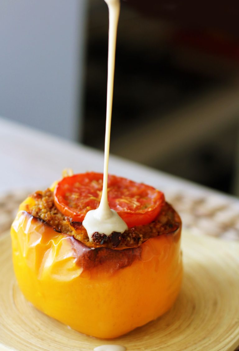 Couscous stuffed peppers topped with herbs