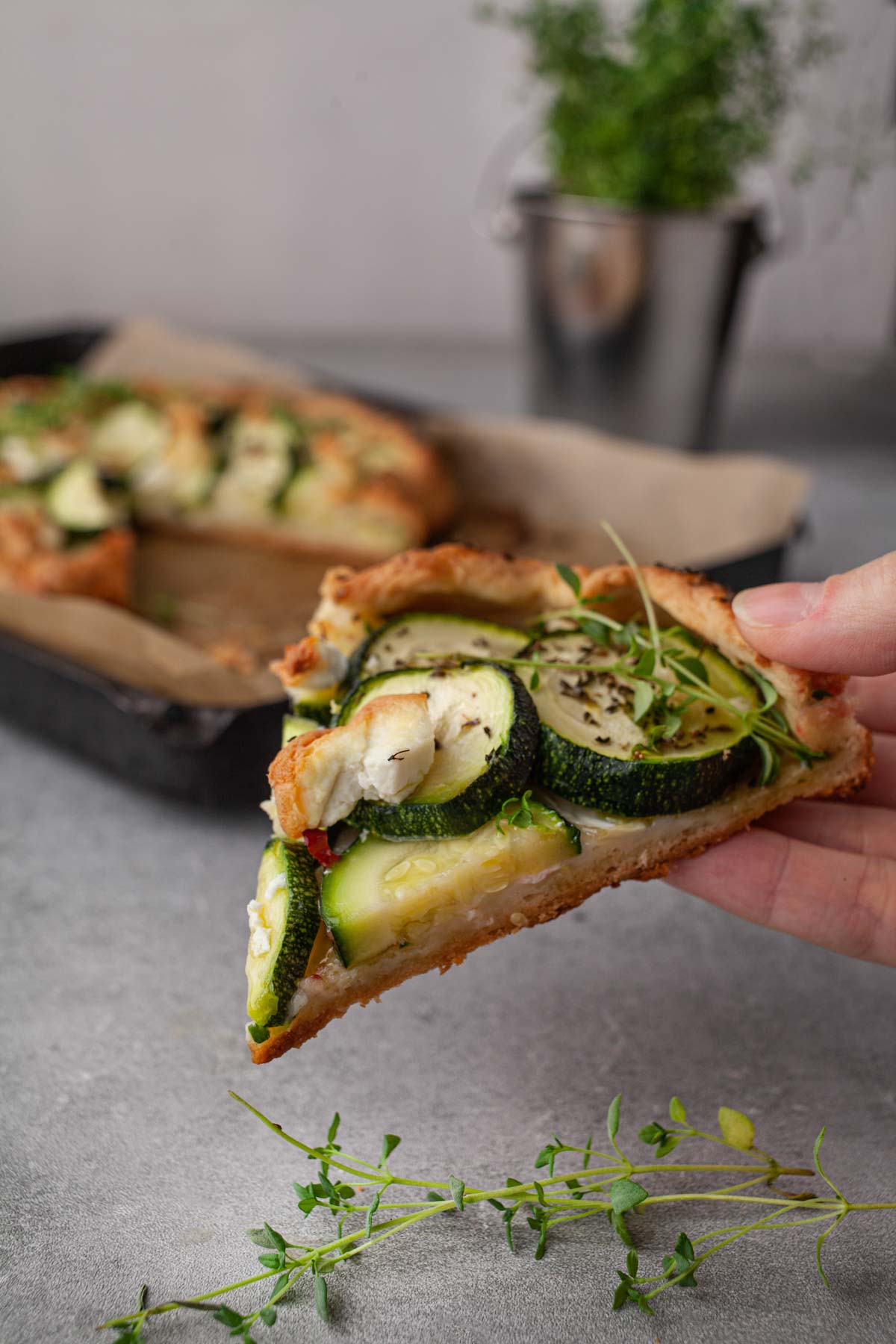 Zucchini galette topped with creamy goat cheese and fresh thyme