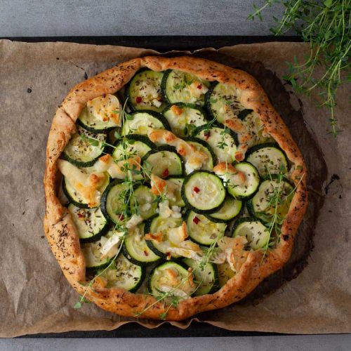 Homemade zucchini galette with goat cheese, sliced and ready to serve
