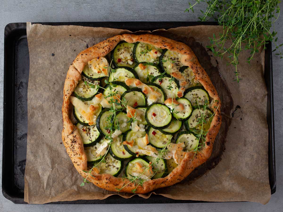 Homemade zucchini galette with goat cheese, sliced and ready to serve