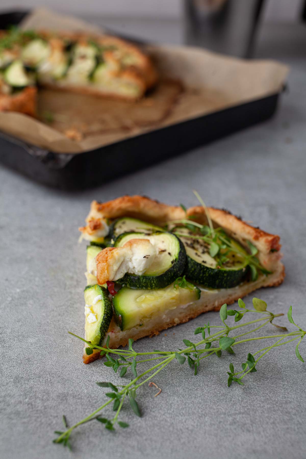 Slice of zucchini and goat cheese galette showing the flaky crust
