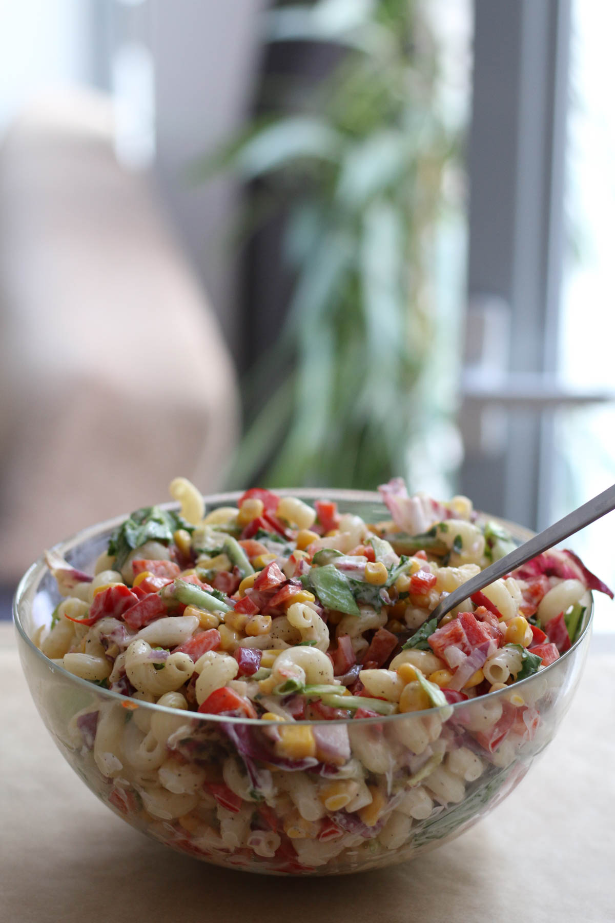 Summer pasta salad in a bowl, ready for a picnic