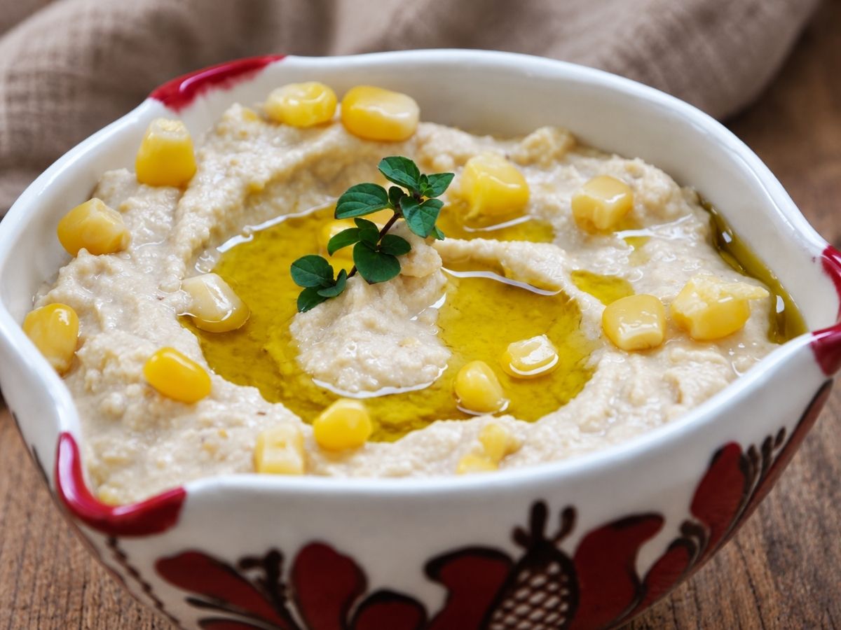 Creamy sweet corn hummus topped with corn kernels