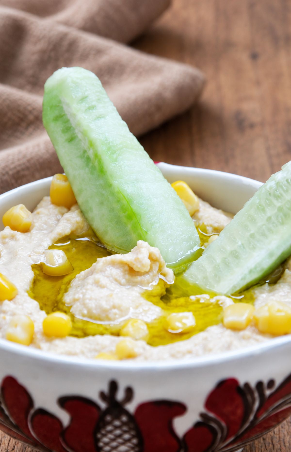 Sweet corn hummus in a bowl drizzled with olive oil