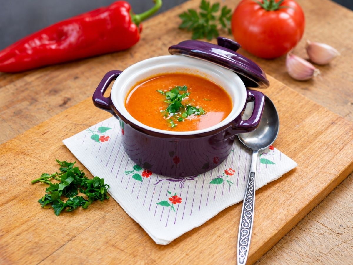 Roasted tomato and red pepper soup topped with fresh basil