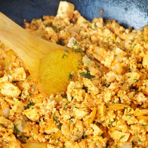 Smoky tofu scramble with mushrooms and quinoa in a skillet