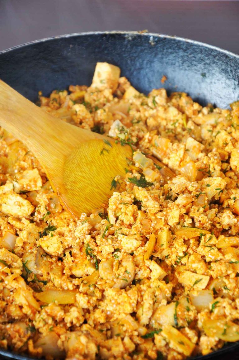 Smoky tofu scramble with mushrooms and quinoa in a skillet