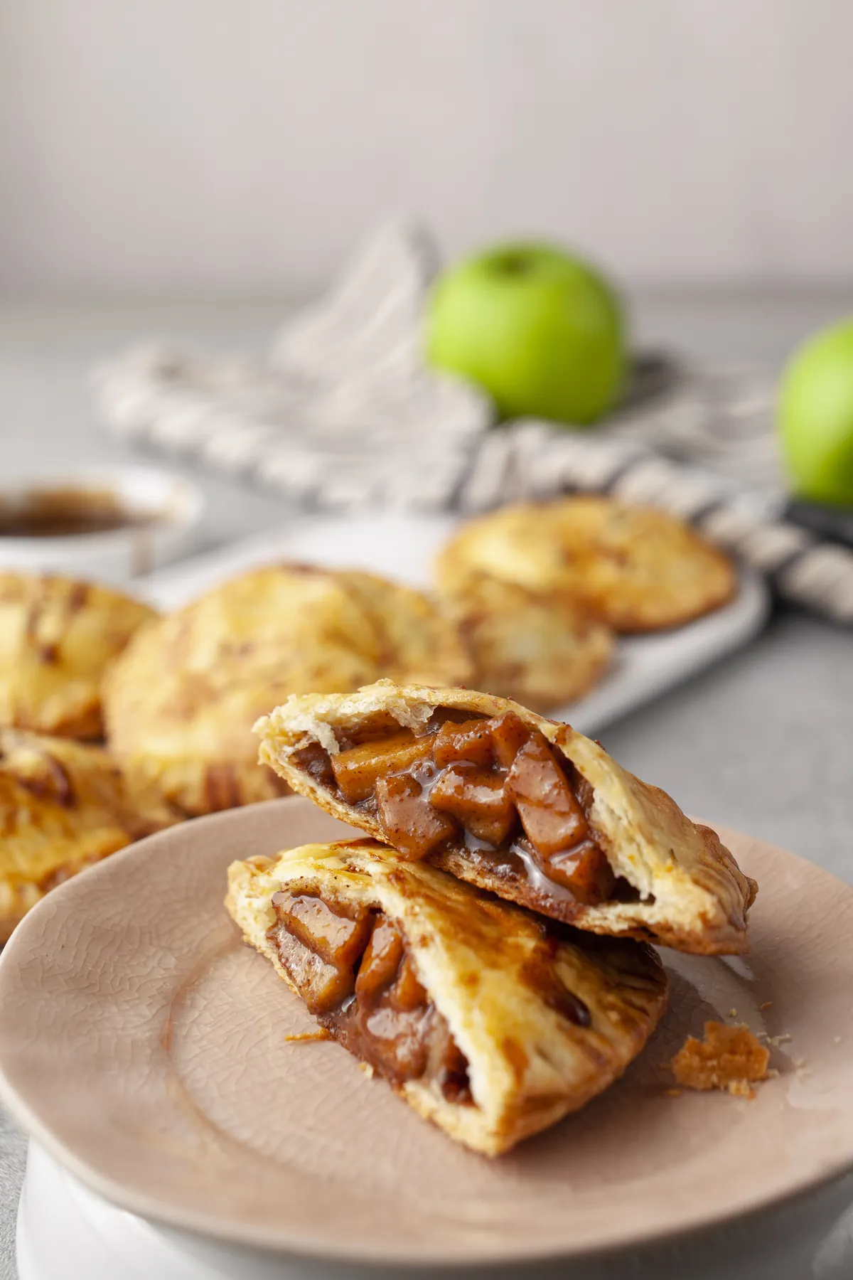 Apple hand pie broken in half, showing the chunky cinnamon apple filling